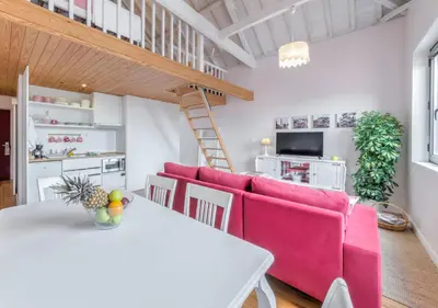 a bedroom with a white bed and a wooden ceiling at Look At Me - Serviced Lofts & Studios in Porto