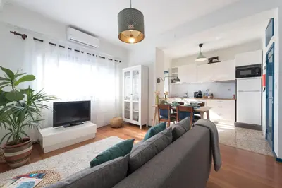a living room with a couch and a kitchen at All in flat by, city center, skyline in Porto
