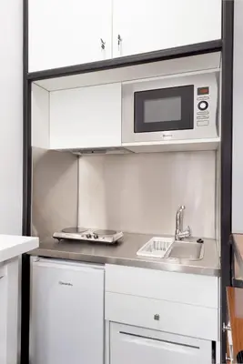 a kitchen with a sink and a microwave at Porto National Theatre Trendy Houses in Porto