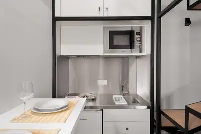 a small kitchen with a sink and a microwave at Porto National Theatre Trendy Houses in Porto