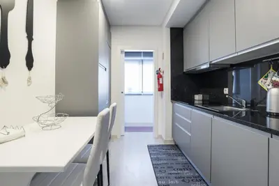 a kitchen with white cabinets and a counter top at Metropolitan Gaia-Porto in Vila Nova de Gaia