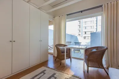 a dining room with a table and chairs and a window at The Art Porto - Holiday Homes in Porto