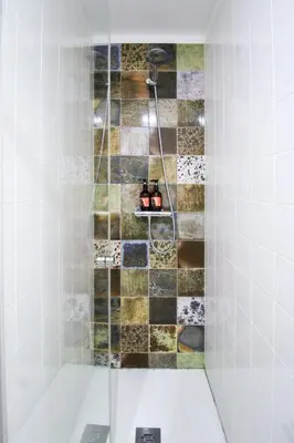 a shower with a glass door in a bathroom at Charming Studio in Historic Downtown in Porto