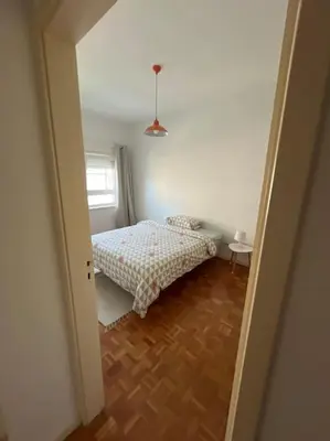 a living room with a room with a couch and a mirror at 26/3 Casa da Música in Porto
