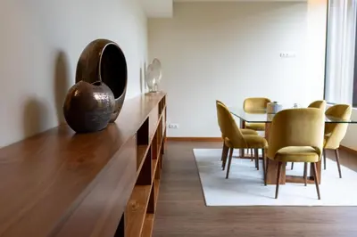 a hotel room with a large bed and a desk at Boeira Garden Hotel Porto Gaia, Curio Collection by Hilton in Vila Nova de Gaia