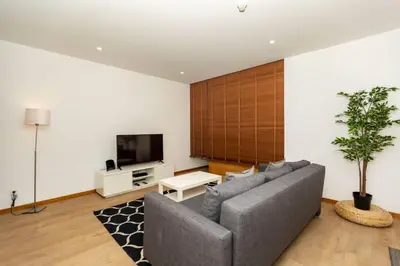 a living room with a couch and a tv at Eiffel Porto in Porto