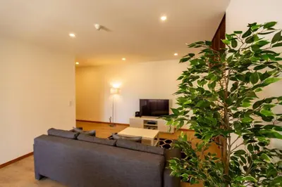 a living room with a couch and a tv at Eiffel Porto in Porto