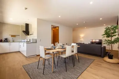 a kitchen and a dining room with a table and chairs at Eiffel Porto in Porto