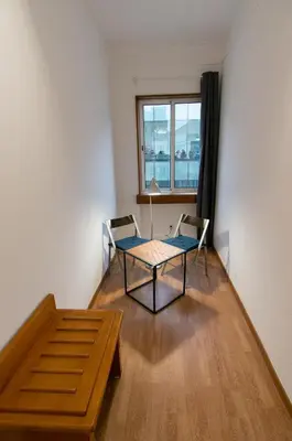 a room with a table and chairs and a window at Change The World Hostels - Porto - Santa Catarina in Porto