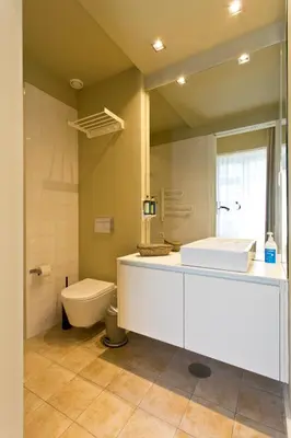 a bathroom with a white sink and a toilet at RVA - Porto Central Flats in Porto