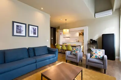 a living room with a blue couch and chairs at RVA - Porto Central Flats in Porto