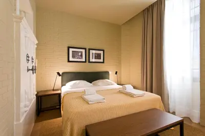 a bedroom with a bed with two towels on it at RVA - Porto Central Flats in Porto