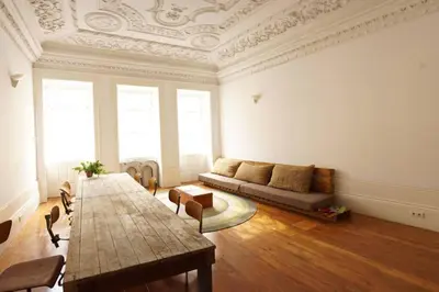 a living room with a couch and a table at Alegria 1º in Porto