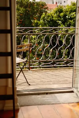 a bench sitting on a balcony with a fence at Alegria 1º in Porto