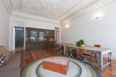 a large room with a wooden table and a couch at Alegria 1º in Porto