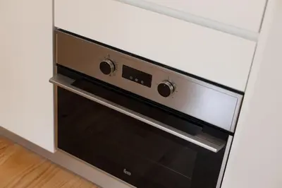a black oven in a kitchen with white walls at Sweet Flat 4Two in City Center, Balcony & Air Conditioning in Porto