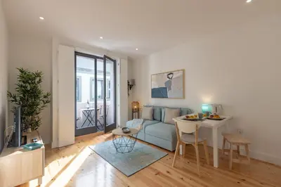 a living room with a couch and a table at Sweet Flat 4Two in City Center, Balcony & Air Conditioning in Porto