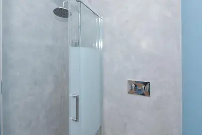 a shower with a glass door in a bathroom at Invicta Oporto Residence in Porto