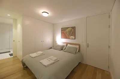 a bedroom with a bed with two towels on it at FLH Porto Spacious Duplex in Porto