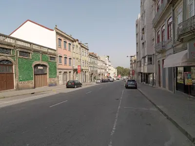 an empty street with cars parked on the side of the road at FLH Porto Trendy Flat in Porto