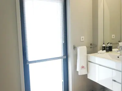a bathroom with a sink and a mirror at Serra do Pilar Porto Suites in Vila Nova de Gaia