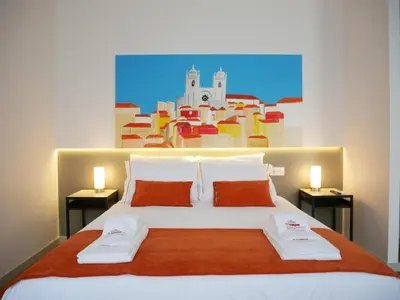 a bedroom with a large bed with two towels on it at Serra do Pilar Porto Suites in Vila Nova de Gaia