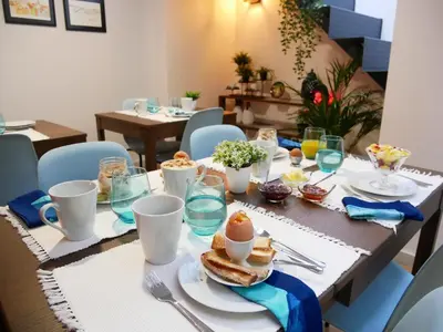 a dining room table with food on top of it at Serra do Pilar Porto Suites in Vila Nova de Gaia