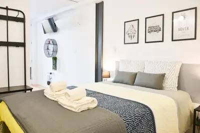 a bedroom with a bed with two towels on it at Comfortable&Central w/balcony-9 min walk Trindade in Porto