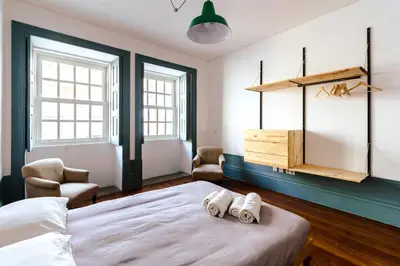 a bedroom with a bed with two towels on it at São Miminho 3º in Porto