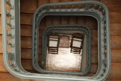 a window in a wall with chairs in it at São Miminho 3º in Porto