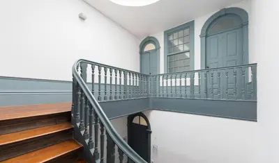a staircase in a house with a black door at São Miminho 3º in Porto