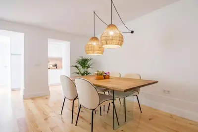 a dining room with a wooden table and chairs at Clérigos 168 in Porto