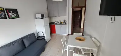 a living room with a blue couch and a table at Tower Records Apartment in Porto