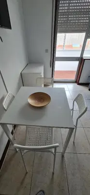 a table and chairs with a plate on top of it at Tower Records Apartment in Porto