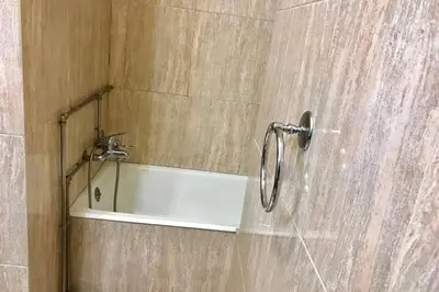 a bathroom with a shower with a mirror and a sink at Tower Records Apartment in Porto