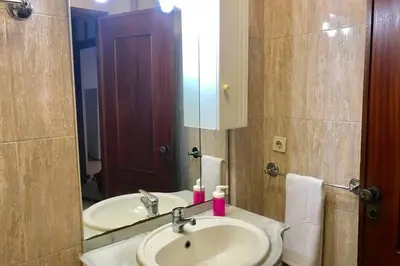 a bathroom with a sink and a mirror at Tower Records Apartment in Porto