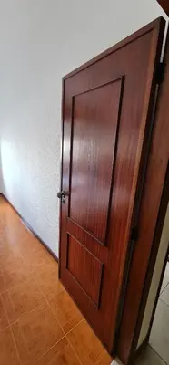 a wooden door in a room with a wooden floor at Tower Records Apartment in Porto