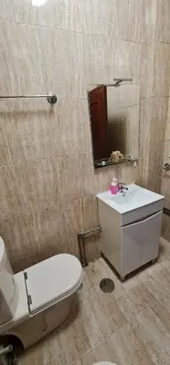 a bathroom with a toilet and a sink and a mirror at Tower Records Apartment in Porto
