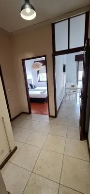 a living room with doors and a room with a table at Tower Records Apartment in Porto