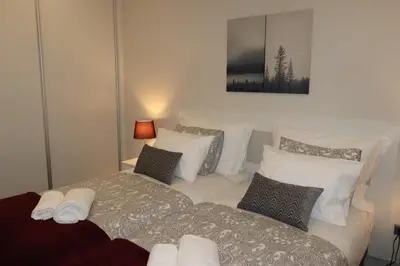 a bedroom with two beds with pillows at A&R Bolhão Apartment in Porto