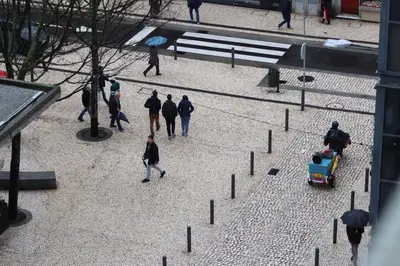 a group of people walking down a street at A&R Bolhão Apartment in Porto