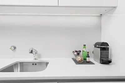 a kitchen counter with a sink and a kitchenilit at Stylish apartment at Bolhao in Porto