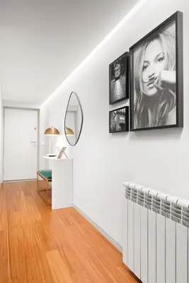 a white living room with a picture of a woman on the wall at Stylish apartment at Bolhao in Porto