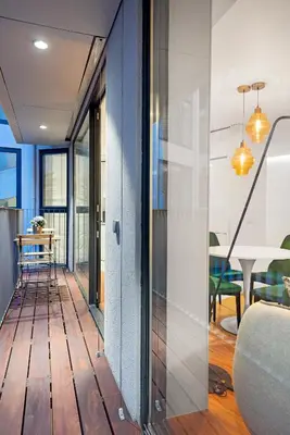 a living room with a wooden floor and glass doors at Stylish apartment at Bolhao in Porto