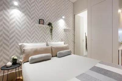 a living room with two white chairs and a television at Sol Modern Studio @ Batalha in Porto