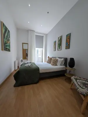a bedroom with a bed and a chair in it at House, view of Bolhão market in Porto