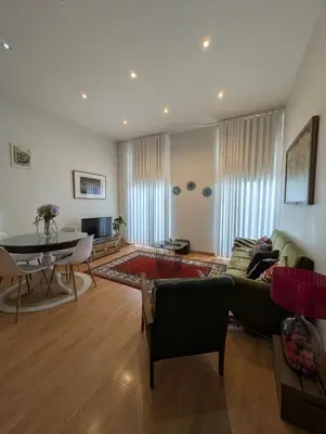 a living room with a couch and a table at House, view of Bolhão market in Porto