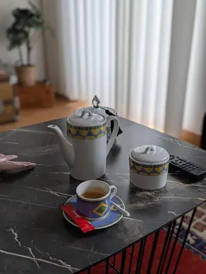 a table with two cups of coffee on it at House, view of Bolhão market in Porto