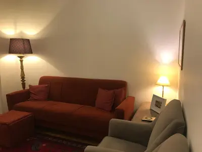 a living room with a couch and a chair at Alegria Cozy com Terraço - Centro do Porto in Porto