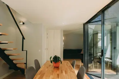 a dining room with a wooden table and chairs at Oporto Maison Palace in Porto